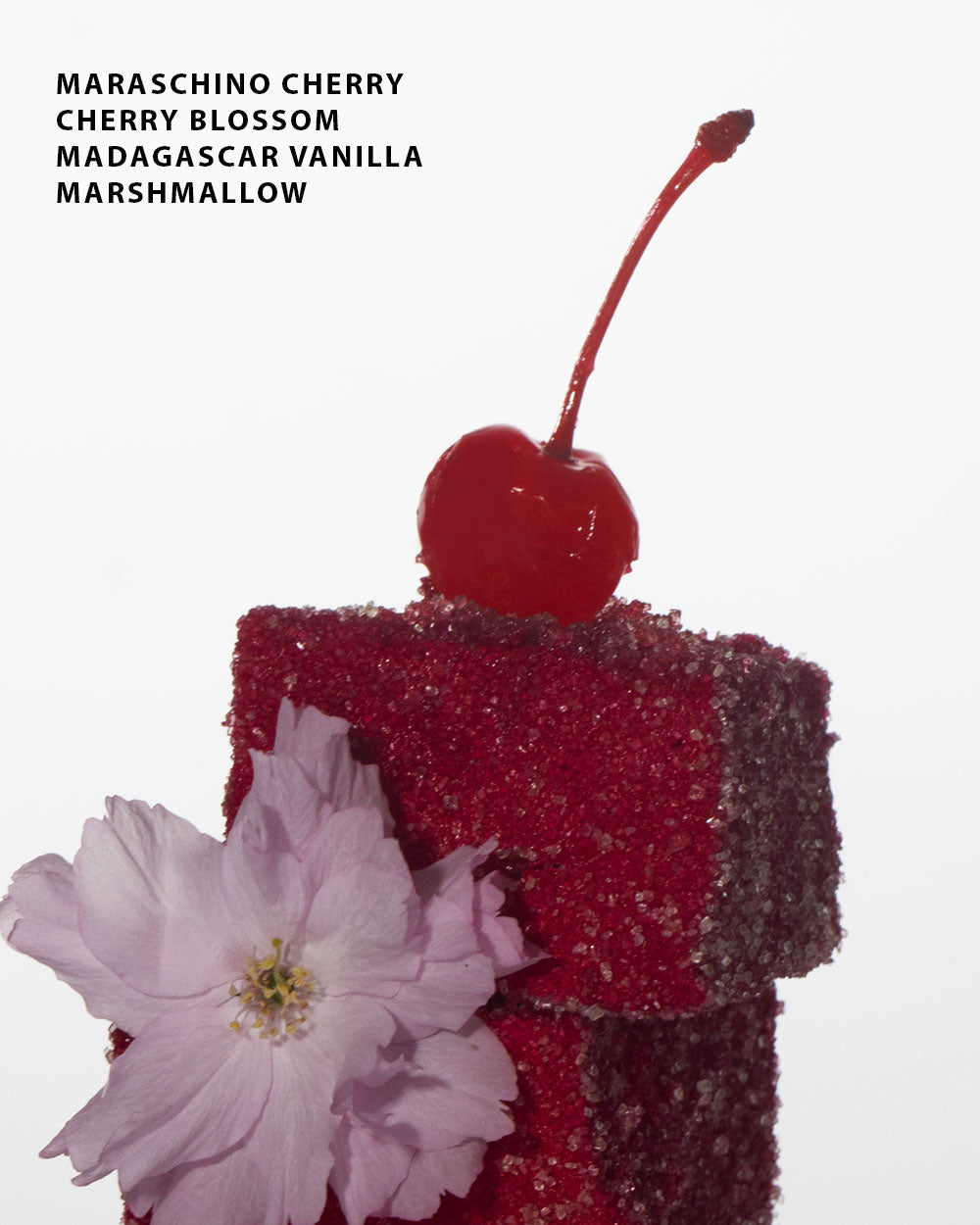 cherry and marshmallow with a text overlay that says the notes "Maraschino Cherry, Cherry Blossom, Madagascar Vanilla and Marshmallow"