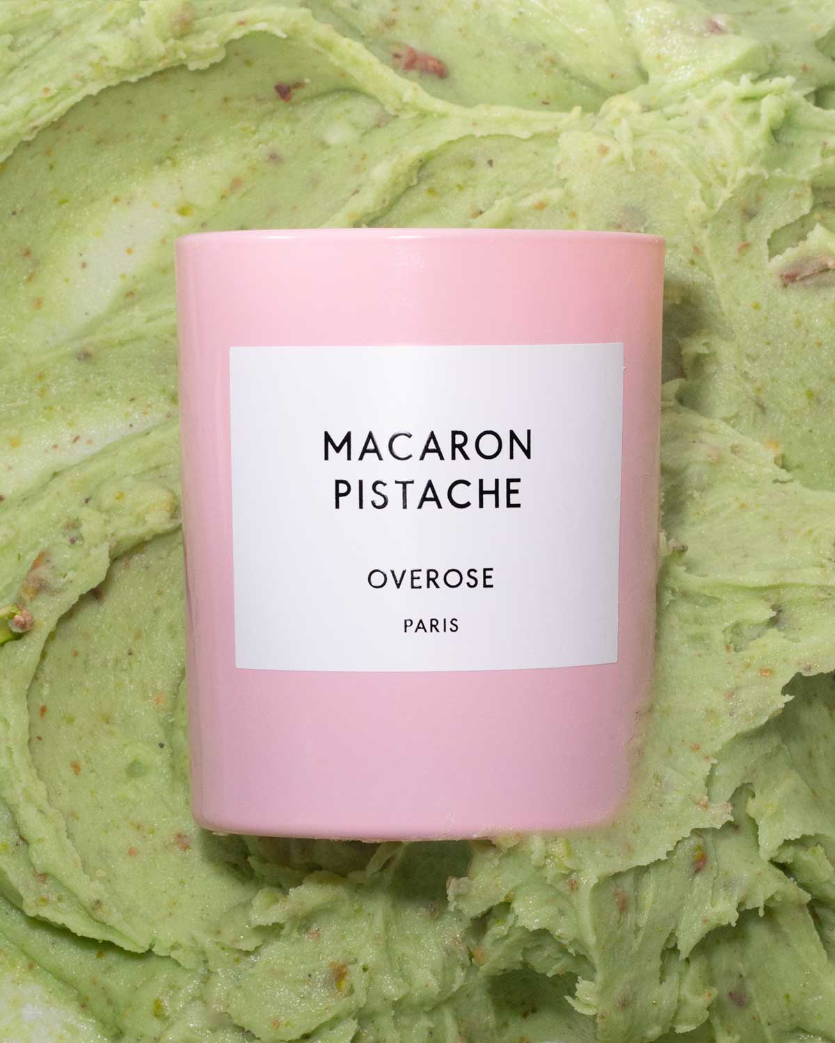 Macaron Pistachio labeled candles in front of pistachio cream background
