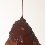 chocolate sauce melting onto a croissant