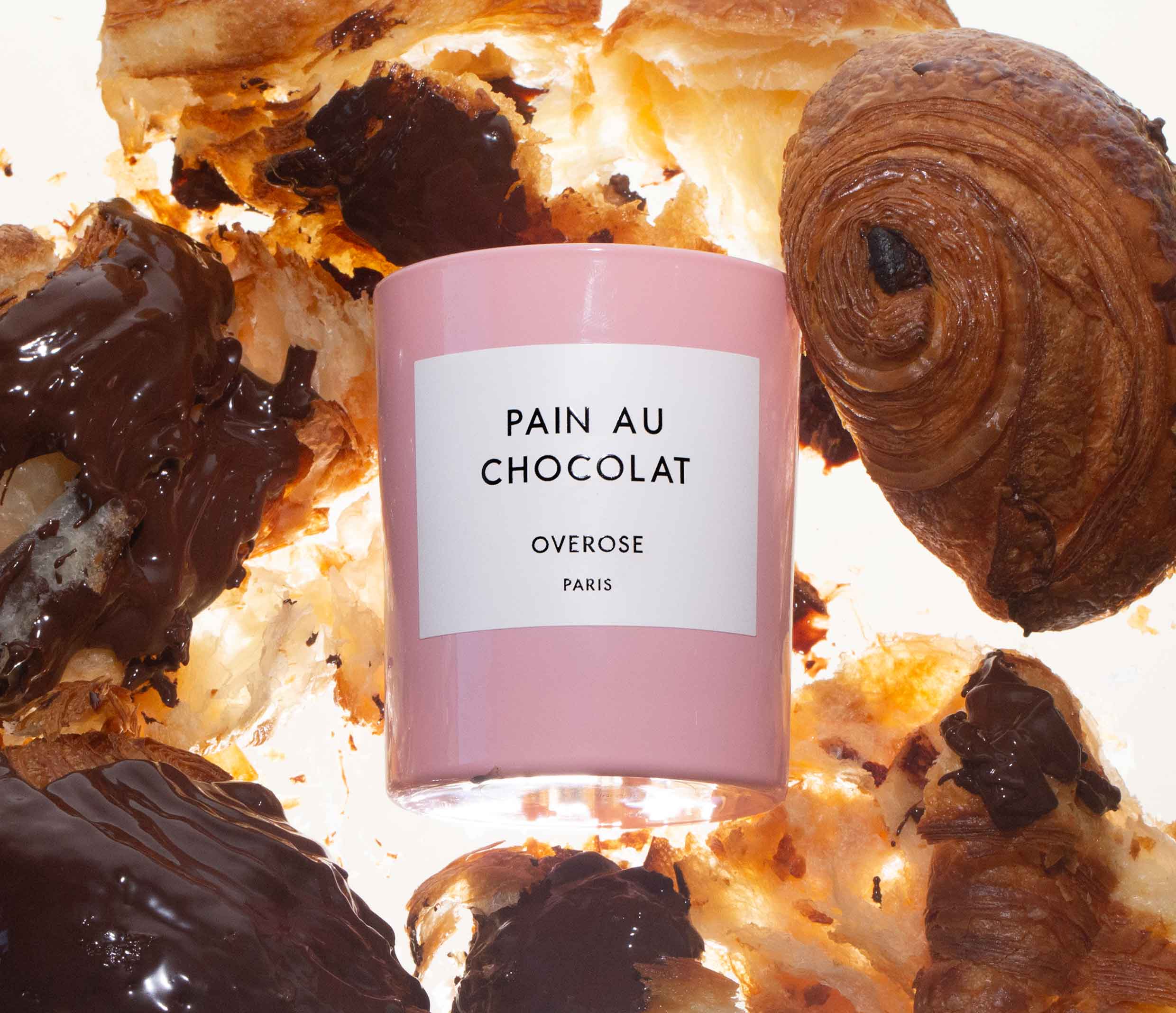 'pain au chocolate' candle surrounded by chocolate croissants