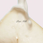 Close-up of a creamy texture with 'Pear Milk' text on a light pink background