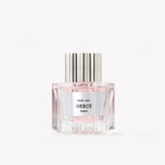 Perfume bottle with silver cap and white label on a light gray background