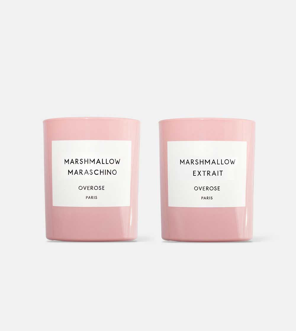 Two pink candles with white labels, one labeled 'Marshmallow Maraschino' and the other 'Marshmallow Extrait'.