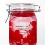 'Marshmallow Marachino' candle inside of a jar of cherries. 