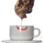 a chocolate babka dipped into a cappuccino cup