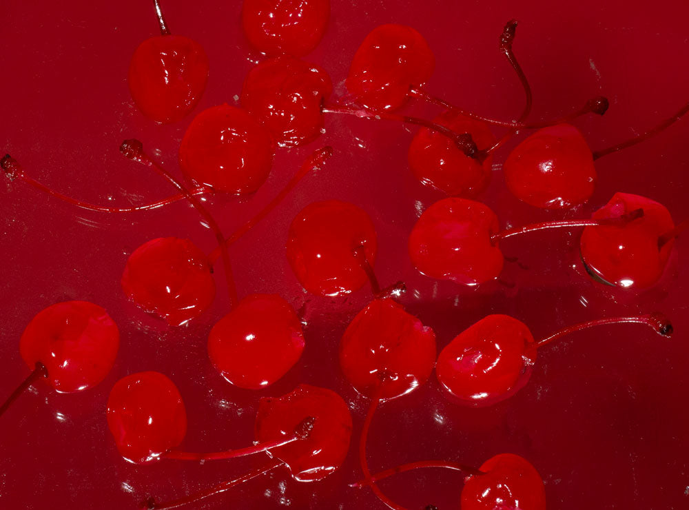 Close-up of red cherries on a red background