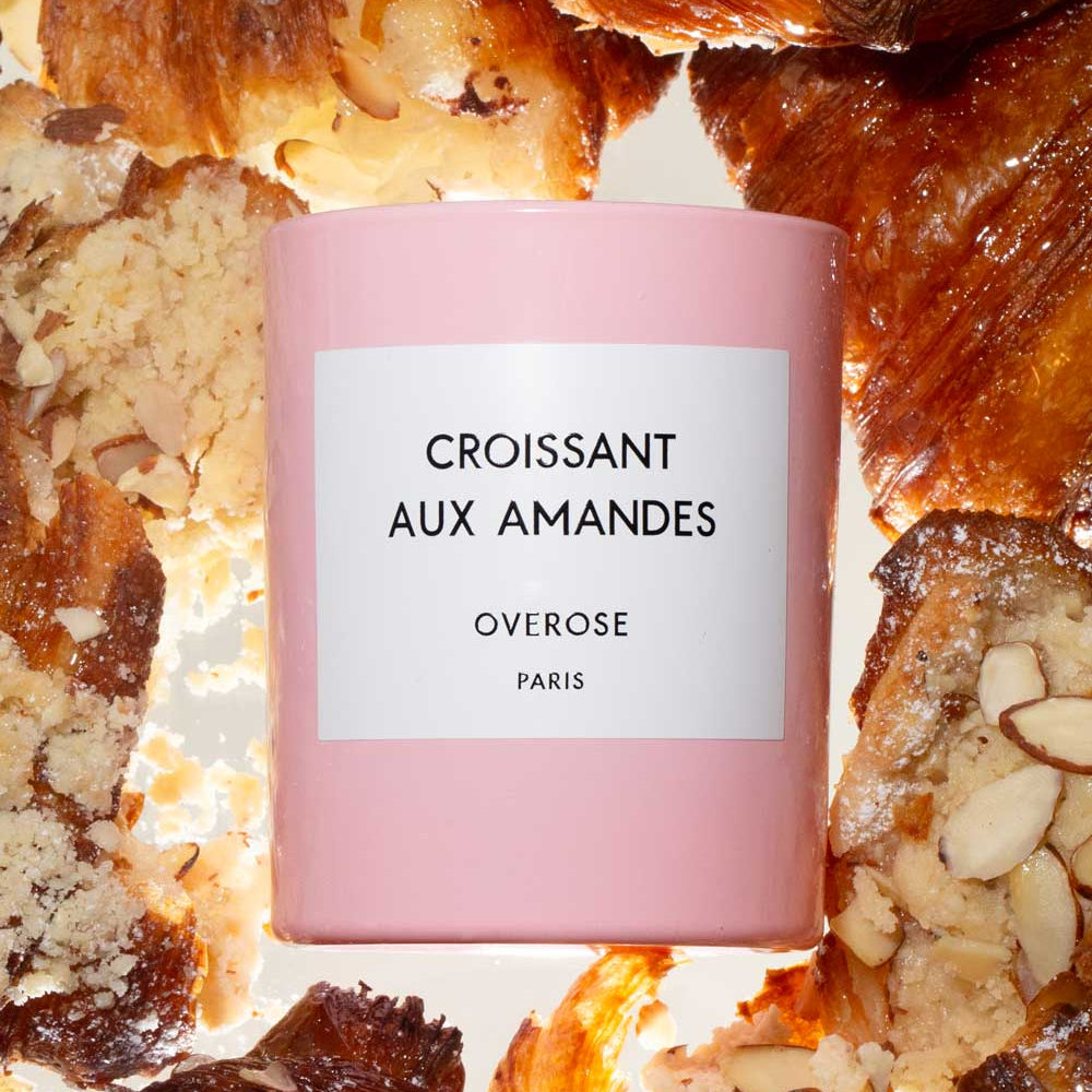"Croissant aux Amandes" labeled Candle in front of Almond Croissants in the background
