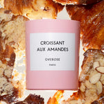 "Croissant aux Amandes" labeled Candle in front of Almond Croissants in the background