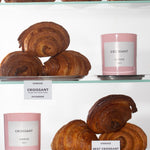 "Croissant" Scented Candles on a shelf with multiple Croissants