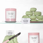 Macaron Pistachio labeled candles on a shelf with multiple pistachio macarons and pistachio cream