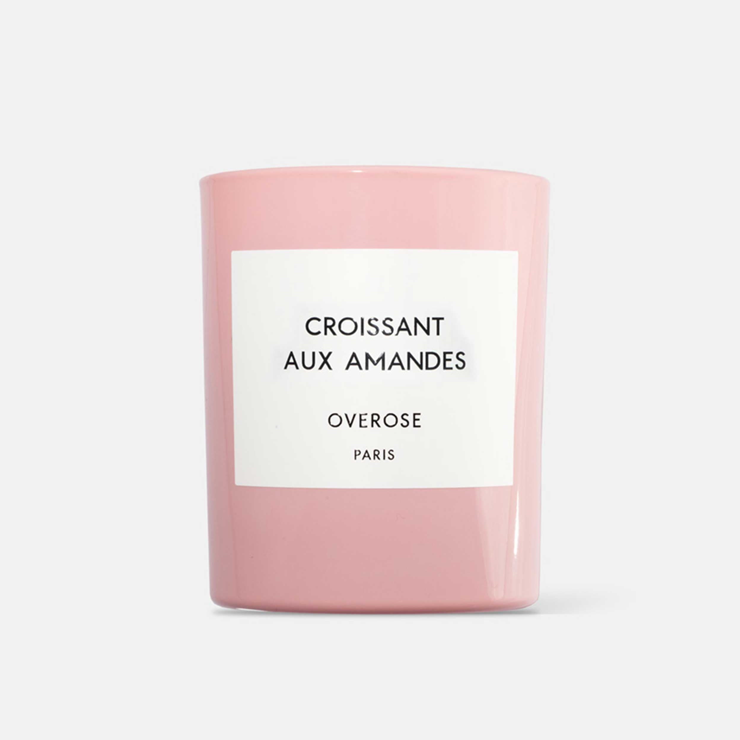 A pink candle with a label that reads 'Croissant aux Amandes' and 'Overose, Paris'.