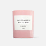 A pink candle with a label that reads 'MARSHMALLOW MARASCHINO'.