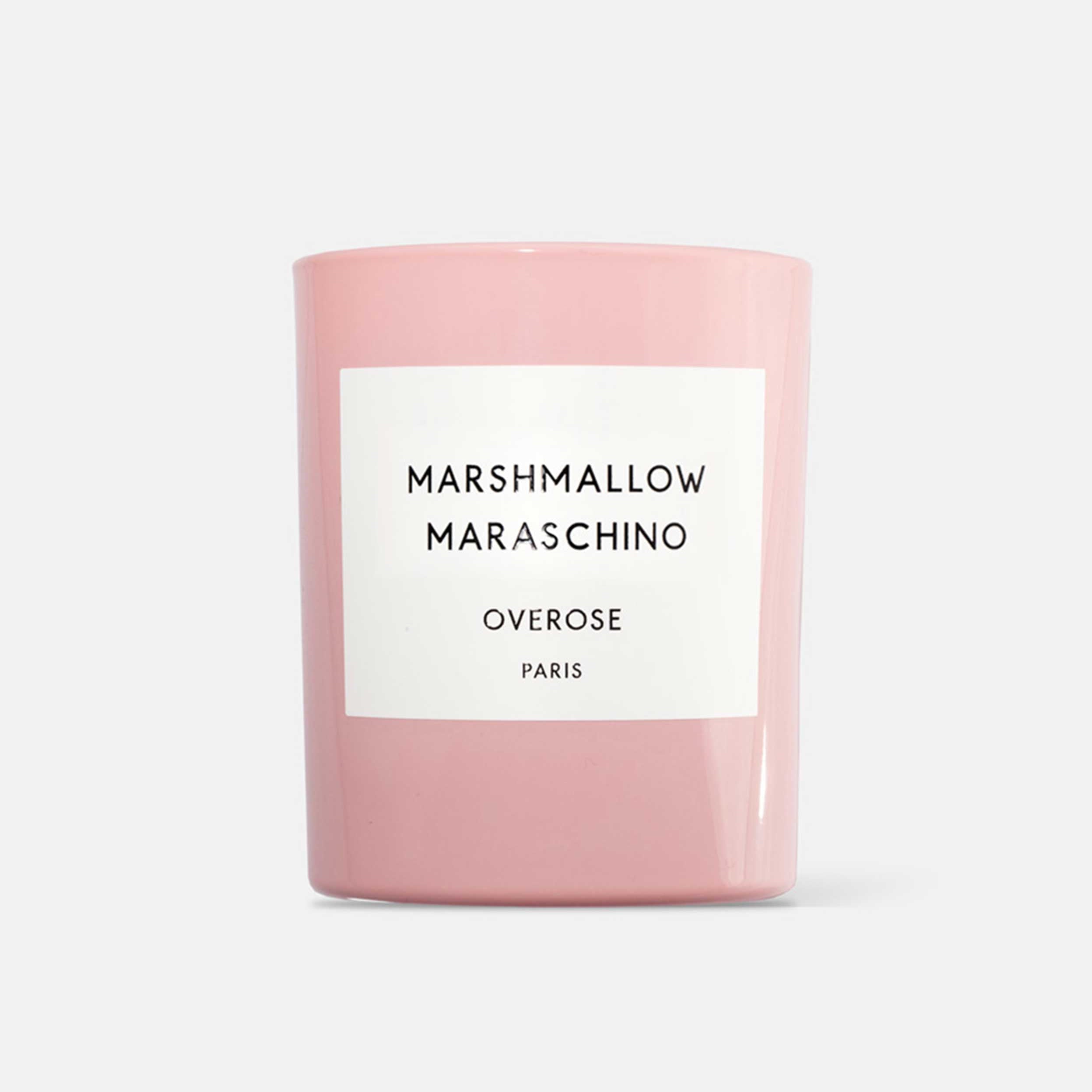 A pink candle with a label that reads 'MARSHMALLOW MARASCHINO'.