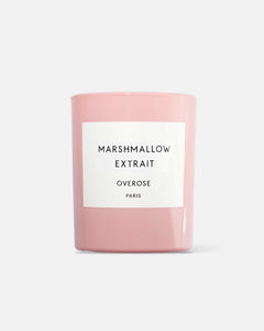 A pink scented candle with the label 'MARSHMALLOW EXTRAIT' on the front.