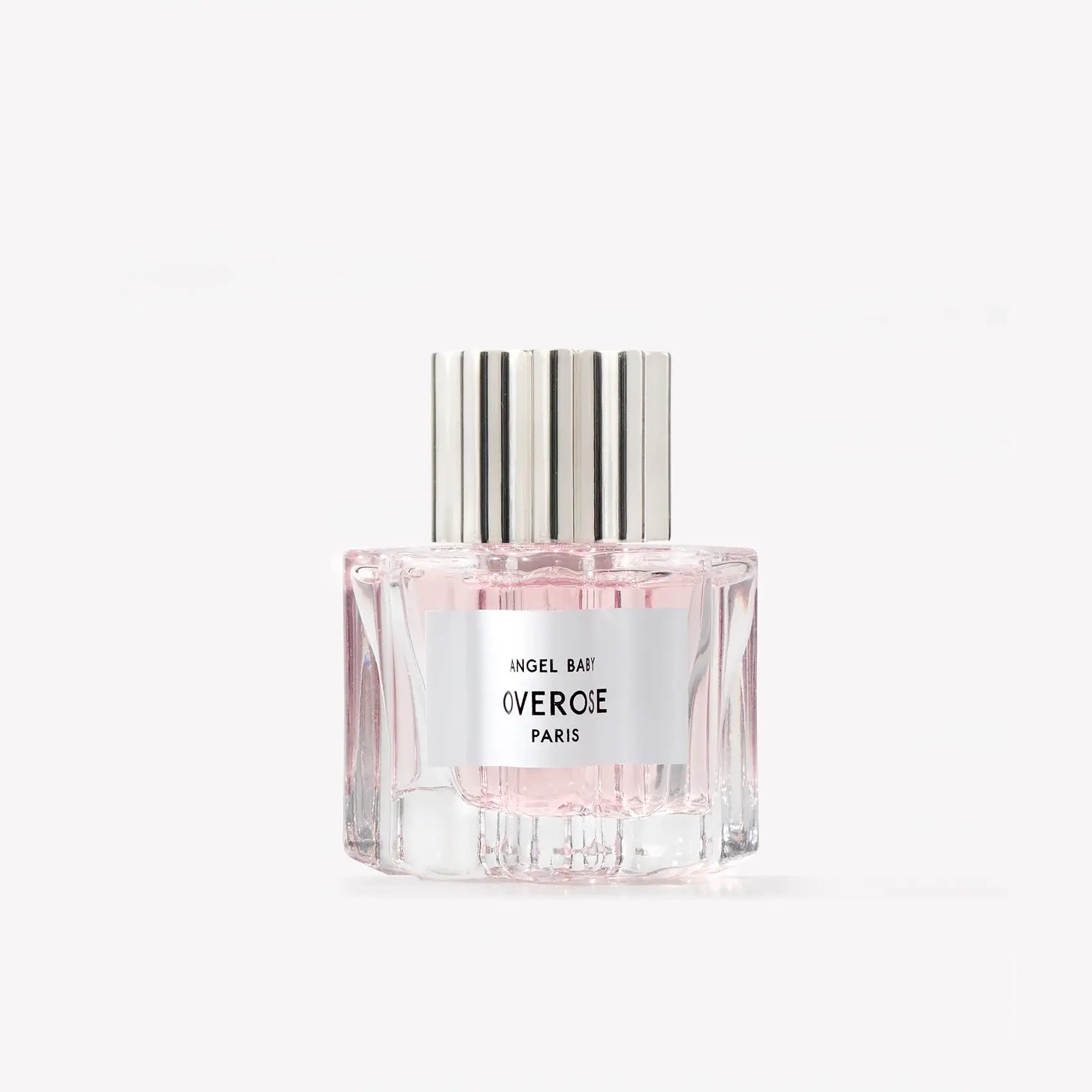 Perfume bottle with silver cap and white label on a light gray background