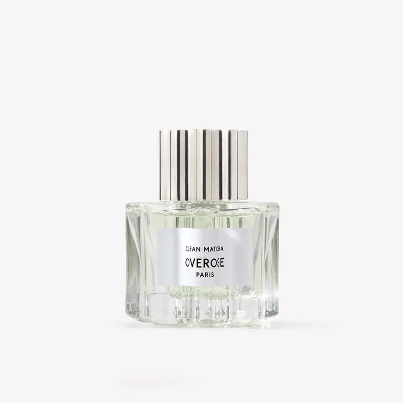 Perfume bottle with silver cap on a white background with 'clean matcha' label
