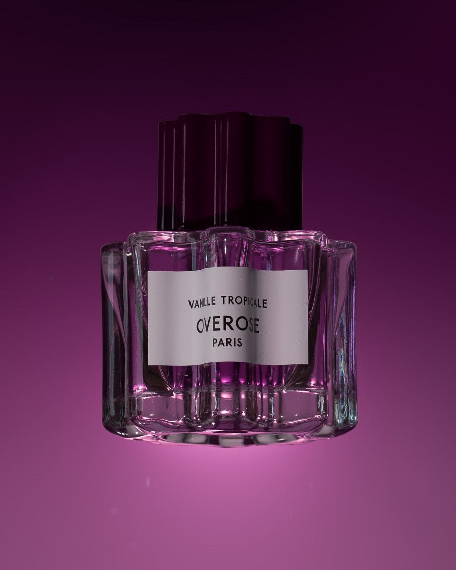 Perfume bottle with 'Overose' label on a purple background