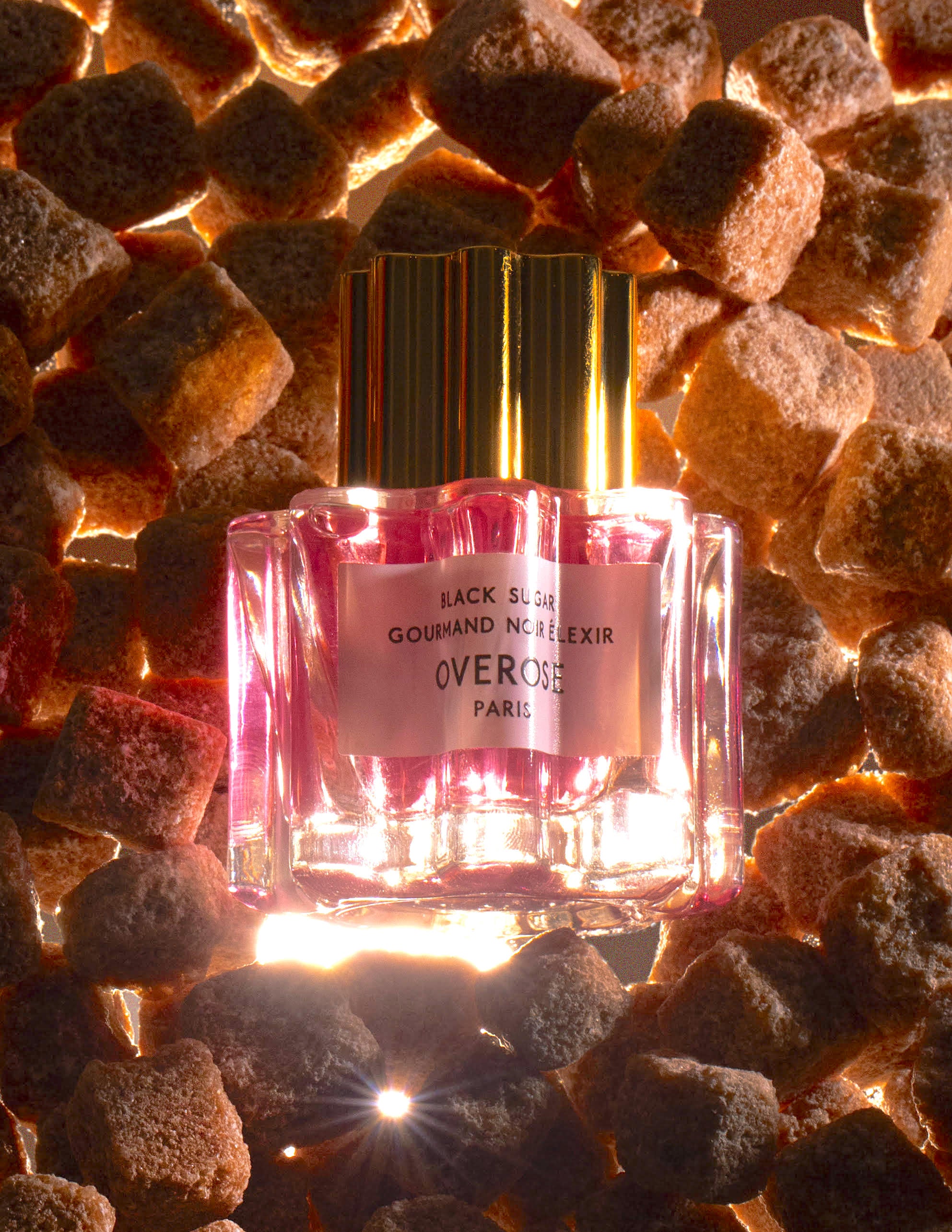 Black Sugar Gourmand Noir Eau de Parfum bottles in front of brown sugar cubes