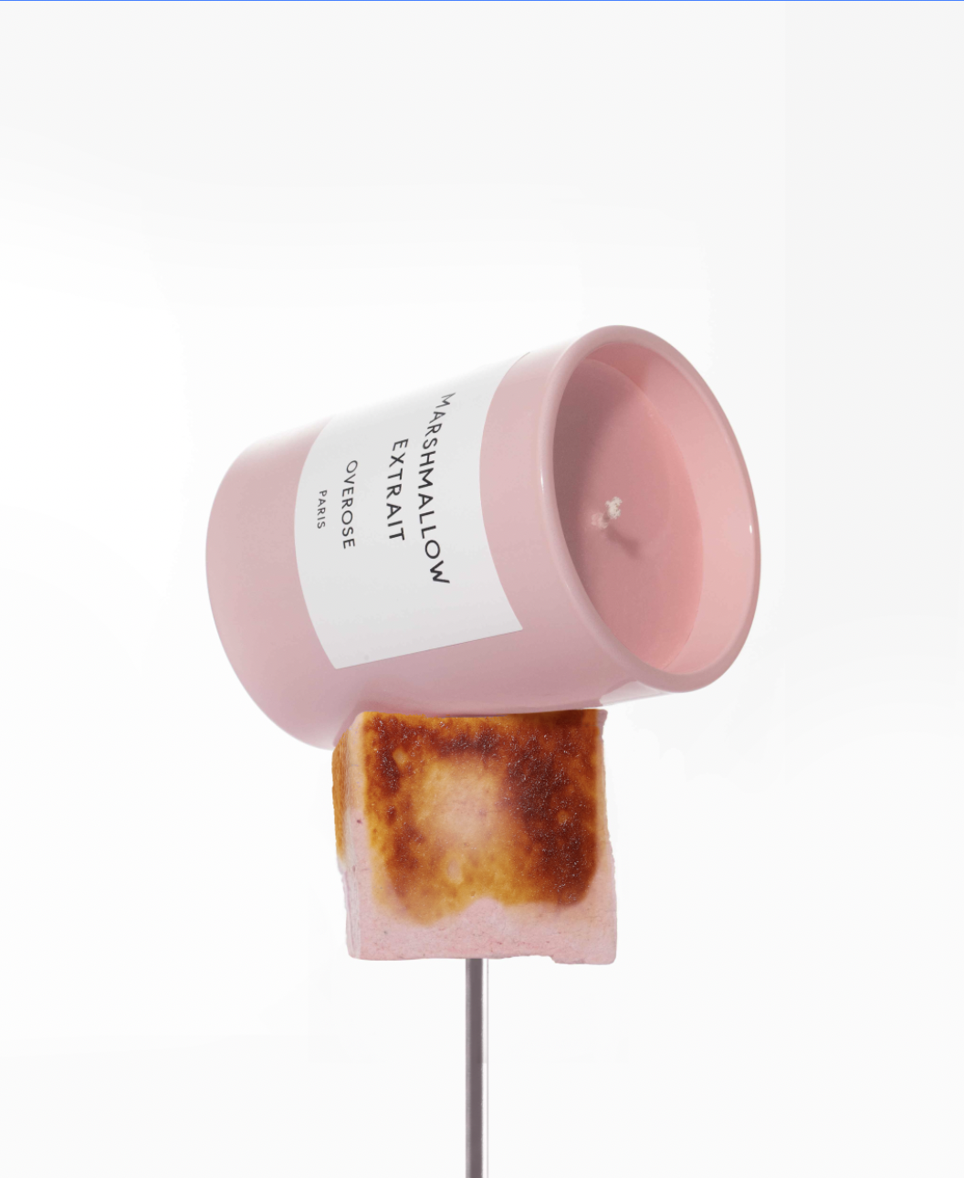 A Marshmallow Extrait candle placed on top of a roasted marshmallow