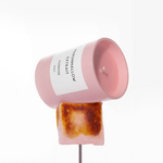 A Marshmallow Extrait candle placed on top of a roasted marshmallow